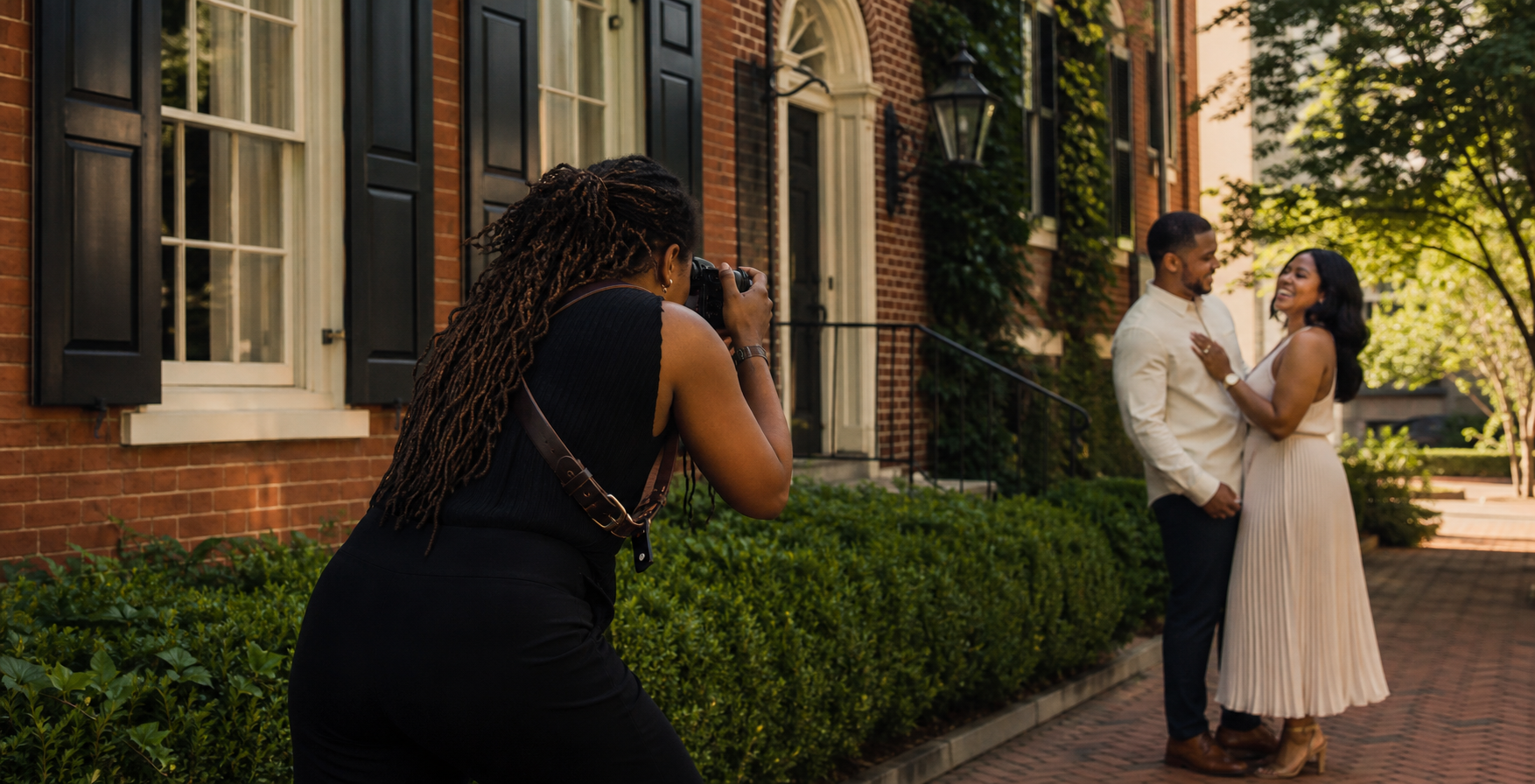A professional photographer photographing an engaged couple
